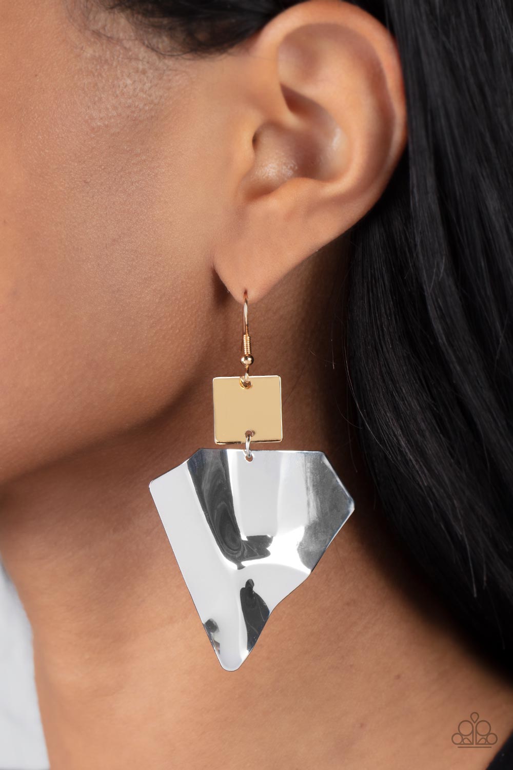 warped silver triangular plate swings from the bottom of a flat gold square frame, creating an abstract lure. Earring attaches to a standard fishhook fitting.  Sold as one pair of earrings.