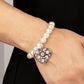 Cutely Crushing - White Pearl Heart Bracelets - Paparazzi dramatically oversized white rhinestone encrusted silver heart charm dangles from a stretchy strand of bubbly white pearls, creating a flirtatious dazzle.  Sold as one individual bracelet.  Paparazzi Jewelry is lead and nickel free so it's perfect for sensitive skin too!