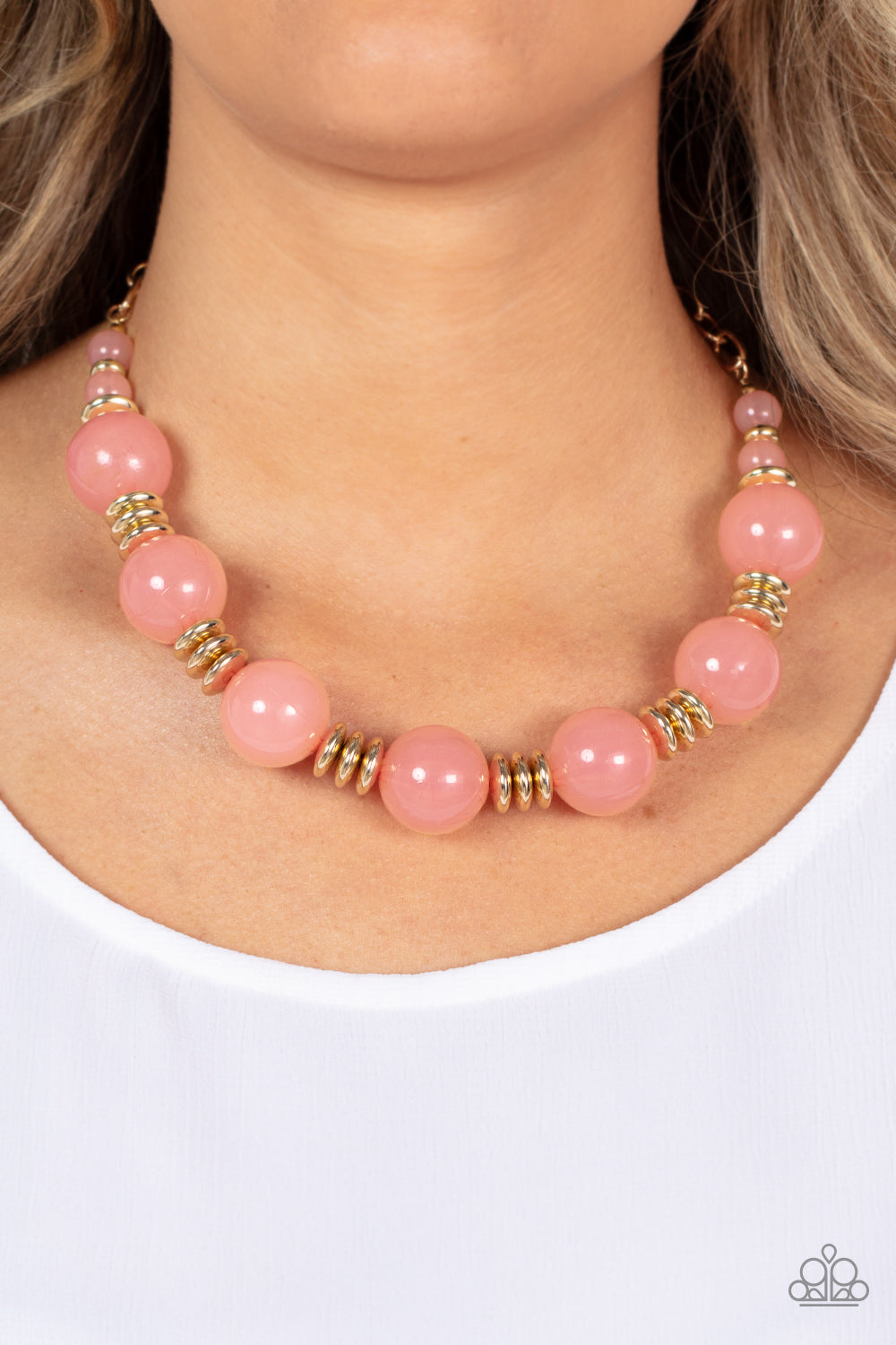 Paparazzi Accessories - Race to the Pop - Pink Necklaces an oversized collection of glassy Pale Rosette beads and shiny gold discs are threaded along an invisible wire, creating a dramatic pop of color below the collar. Features an adjustable clasp closure.  Sold as one individual necklace. Includes one pair of matching earrings.