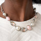 Nautical Nirvana - Pink Iridescent Pearl Necklaces a collection of classic white pearls, iridescent Pale Rosette beads, white emerald cut gems, and iridescent crystal-like teardrops dance below the collar for an ethereal display. Shiny silver frames encase each bead, adding a romantic vibe to the vintage inspired design. Features an adjustable clasp closure.  Sold as one individual necklace. Includes one pair of matching earrings.