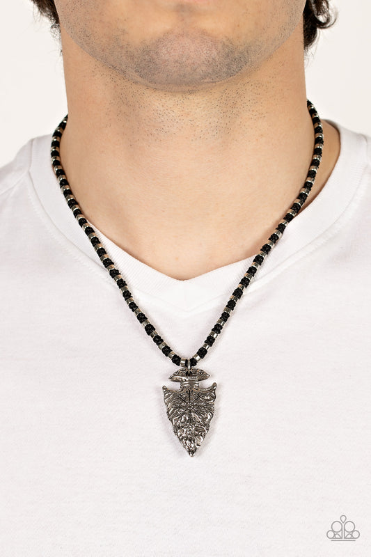 Get Your ARROWHEAD in the Game - Black Arrow Urban Necklaces dainty silver accents are knotted in place along a braided black cord below the collar. Stamped and hammered in tribal inspired patterns, a rustic silver arrowhead pendant swings from the earthy display for an authentic finish. Features a button loop closure. Sold as one individual necklace.