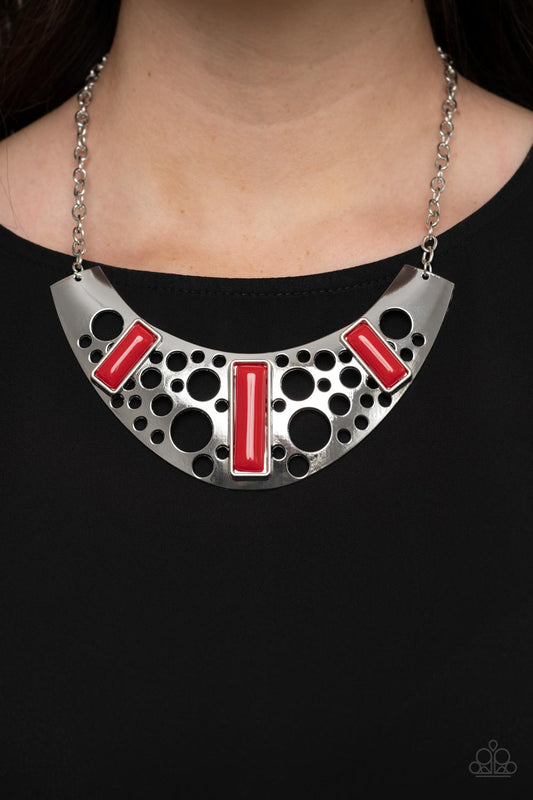 Paparazzi Accessories - Real Zeal - Red Necklaces dotted with fiery red beaded accents, an oversized silver plate is stenciled in bubbly cutouts as it glistens below the collar for a dramatic fashion. Features an adjustable clasp closure.  Sold as one individual necklace. Includes one pair of matching earrings.