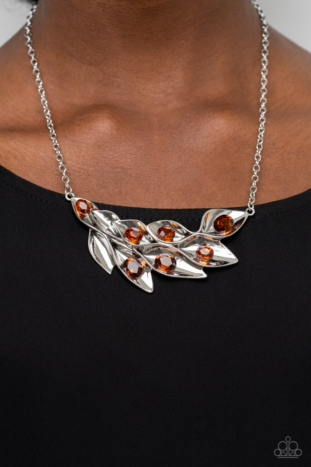 Paparazzi Accessories - Enviable Elegance - Brown Leaf Necklaces a rustic collection of leafy silver frames gently fold around their oversized topaz rhinestone centerpieces as they delicately connect into a swaying pendant, resulting in a radiant shimmer below the collar. Features an adjustable clasp closure.  Sold as one individual necklace. Includes one pair of matching earrings.