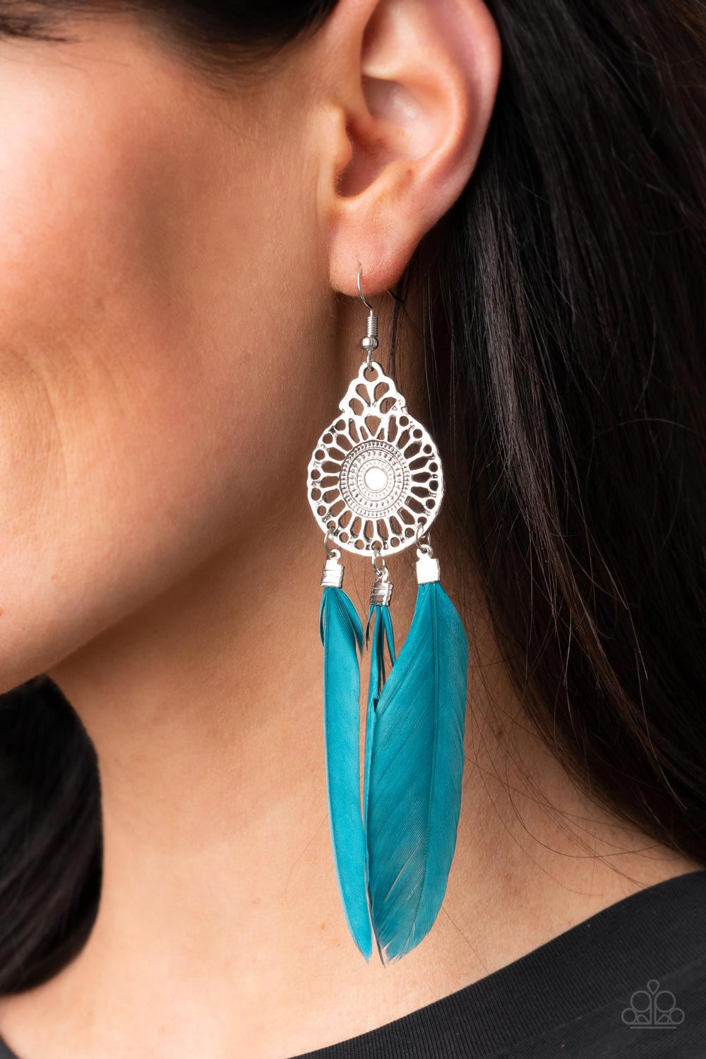 Pretty In PLUMES - Blue Feather Earrings three Mykonos Blue feathers swing from the bottom of a dizzying silver frame featuring airy filigree detail, resulting in a flirtatiously colorful fringe. Earring attaches to a standard fishhook fitting.  Sold as one pair of earrings.