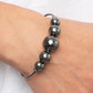 Gradually increasing in size, an oversized collection of gunmetal beads are threaded along a dainty gunmetal cuff for a dramatic industrial display.  Sold as one individual bracelet.