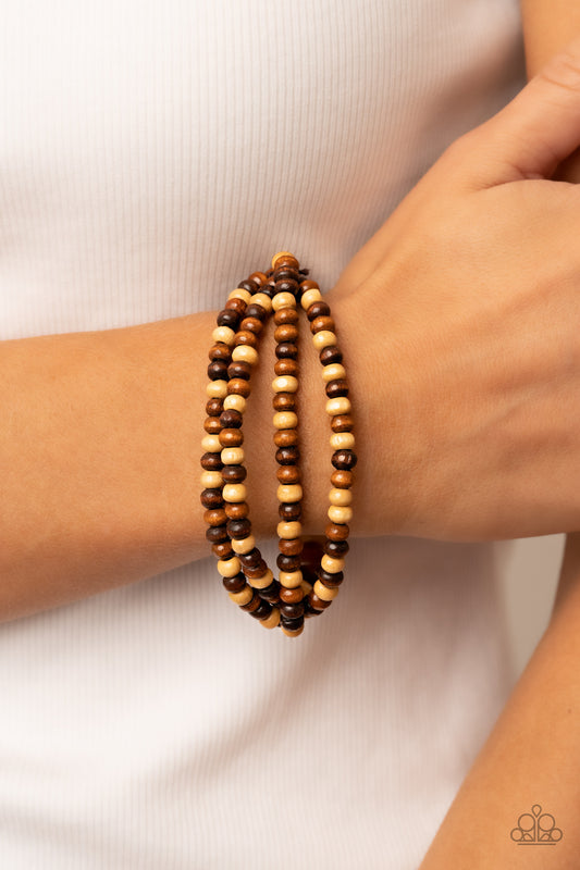 Paparazzi Oceania Oasis - Brown Wood Bracelets varying in natural wooden finishes, stretchy strands of dainty wooden beads attach to a single row of oversized wooden beads around the wrist for an earthy spin on the homespun trend.  Sold as one individual bracelet.