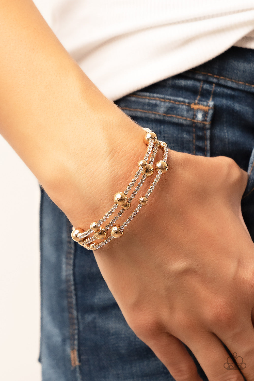 Spontaneous Shimmer - Gold Coil Bracelet spontaneously interrupted by glistening gold beads, a sparkly strand of white rhinestones coils around the wrist, resulting in an irresistible infinity wrap bracelet.  Sold as one individual bracelet.