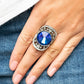 Paparazzi Accessories - Galactic Garden - Blue Gem Ring a dramatically oversized, iridescent blue gem is pressed into the center of an oval silver frame dotted and bordered in glassy white rhinestones, resulting in a sparkly filigree-filled centerpiece atop the finger. Features a stretchy band for a flexible fit. Due to its prismatic palette, color may vary.  Sold as one individual ring.