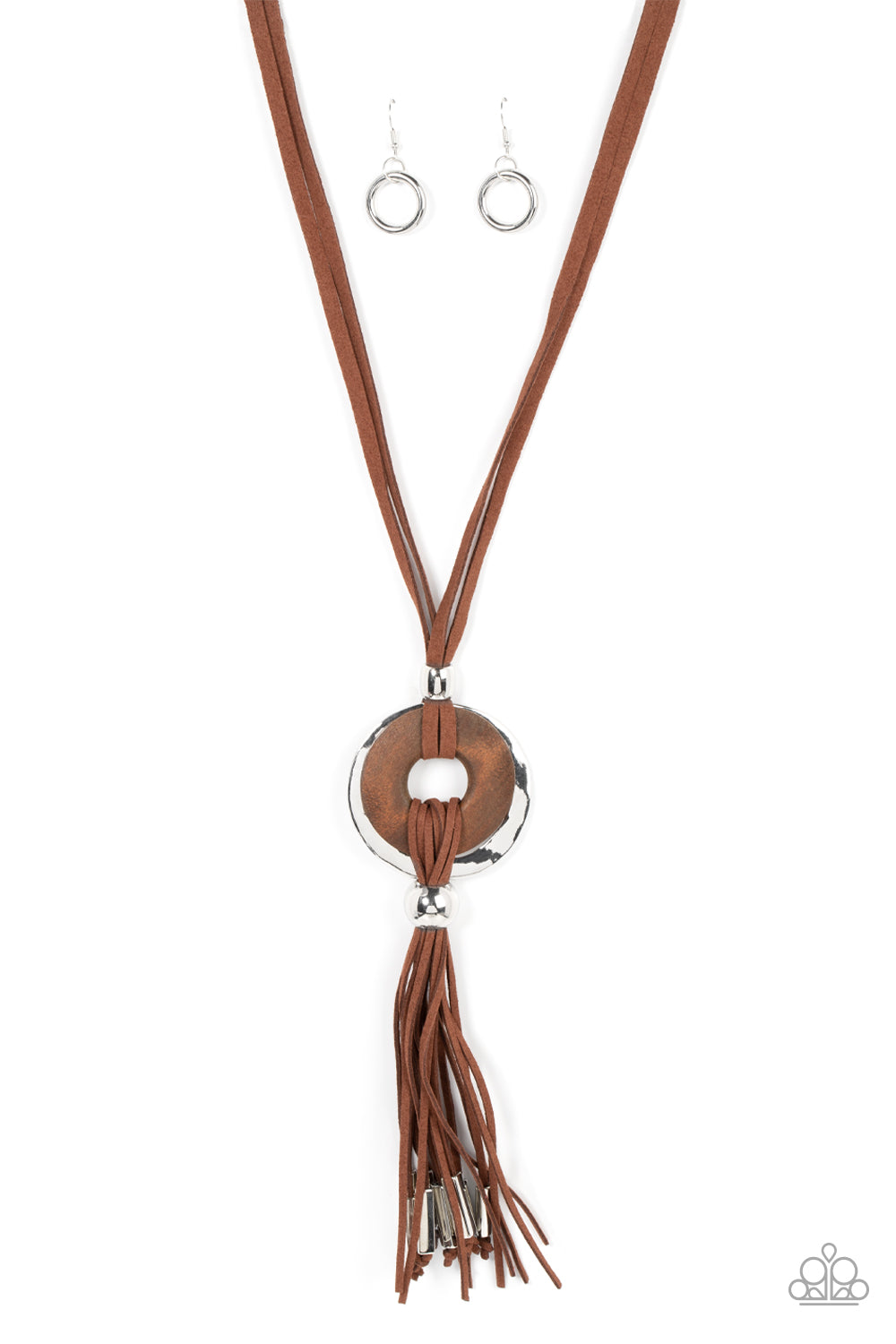 Loops of brown suede knot around a distressed wooden disc and hammered silver disc, resulting in a rustic pendant. The artisan inspired centerpiece gives way to a suede tassel capped in silver fittings, resulting in a noise-making fringe. Features an adjustable clasp closure.  Sold as one individual necklace. Includes one pair of matching earrings.