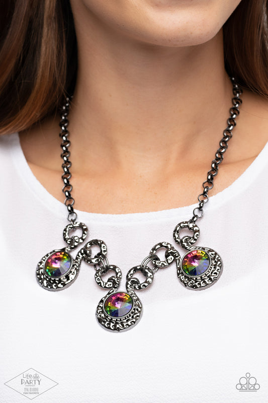 Paparazzi Accessories Hypnotized - Multi Life of the Party Exclusive Necklaces three dramatically oversized oil spill rhinestones are nestled into three textured gunmetal fittings that are connected by oval gunmetal rings, creating a brilliant statement piece. Features an adjustable clasp closure.  Sold as one individual necklace. Includes one pair of matching earrings.