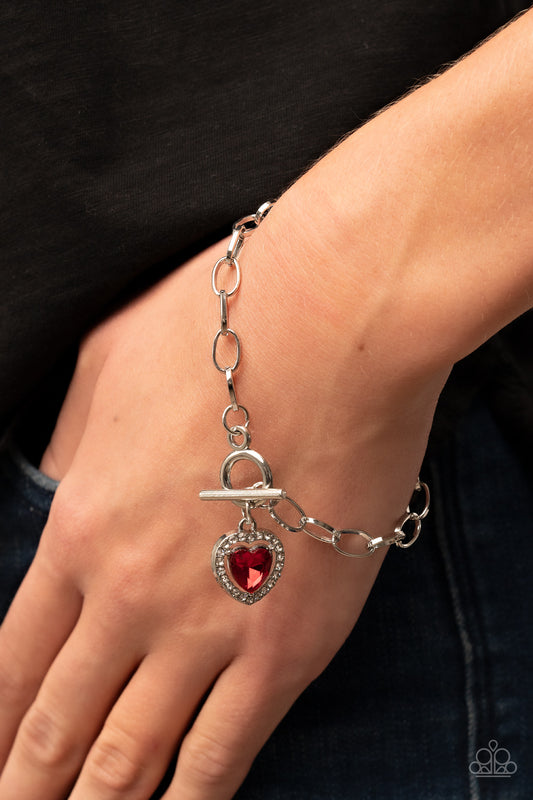 Til DAZZLE Do Us Part - Red Heart Toggle Bracelets bordered in glassy white rhinestones, a red heart shaped gem sparkles from a toggle closure at the center of an oval silver linked chain for a flirtatious fashion around the wrist. Features a toggle closure.  Sold as one individual bracelet.