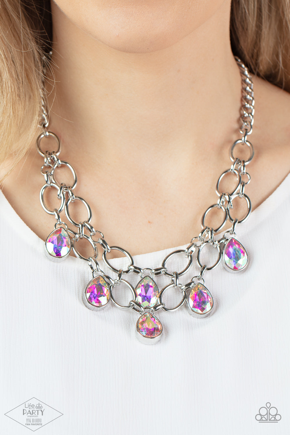 Paparazzi Show-Stopping Shimmer - Iridescent Necklaces joined by dainty silver links, two rows of dramatic silver chain layer below the collar in a fierce fashion. Iridescent teardrop gems drip from the glistening layers, adding a timeless shimmer to the show-stopping piece. Features an adjustable clasp closure.  Sold as one individual necklace. Includes one pair of matching earrings.  Life of the Party Exclusive 