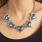 Paparazzi Kindred Hearts - White Heart Necklaces bordered in glassy white rhinestones, an oversized collection of beveled silver heart frames delicately links below the collar for a dramatically romantic look. Features an adjustable clasp closure.  Sold as one individual necklace. Includes one pair of matching earrings.