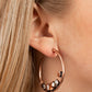 Paparazzi Attractive Allure - Copper Hoop Earrings featuring various cuts and shimmer, mismatched white, copper aurum and coppery rhinestones delicately collect along the bottom of an antiqued copper hoop for a glitzy accent. Earring attaches to a standard post fitting. Hoop measures approximately 1 3/4" in diameter.  Sold as one pair of hoop earrings.