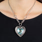 Paparazzi Heart Full of Fabulous - Blue Heart Necklaces bordered in spun silver ribbons, an oversized blue heart gem is pressed into a silver heart frame below the collar. The flirtatious pendant attaches to silver rings and decorative silver frames dotted in white rhinestones, resulting in a dash of vintage inspired romance. Features an adjustable clasp closure.  Sold as one individual necklace. Includes one pair of matching earrings.