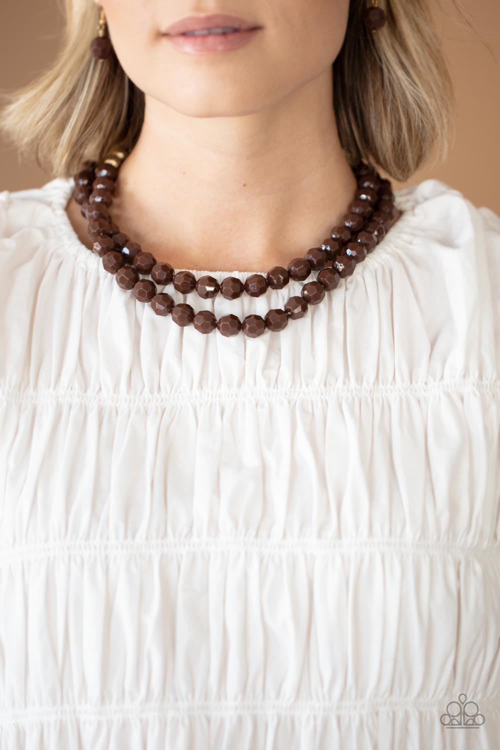 Paparazzi Accessories - Greco Getaway - Brown Necklaces faceted Coca Mocha and golden acrylic beads are threaded along invisible wires below the collar, creating a modern pop of color.  Sold as one individual necklace. Includes one pair of matching earrings.  Get The Complete Look! Bracelet: "Grecian Glamour - Brown" (Sold Separately)