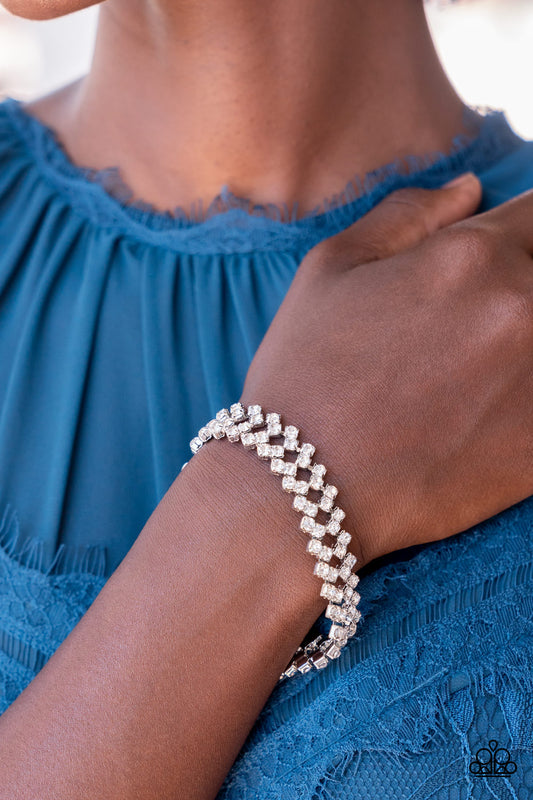 Paparazzi Accessories - Seize the Sizzle - White Rhinestone Bracelets set in pronged silver settings, pairs of icy white rhinestones haphazardly stack around the wrist in sizzling rows of shimmer. Features an adjustable clasp closure.  Sold as one individual bracelet.