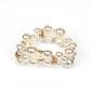 Paparazzi Accessories - Her Serene Highness - Gold Pearl Bracelets bubbly collection of white pearls, dainty gold beads, and white rhinestone encrusted accents are threaded along braided stretchy bands around the wrist, resulting in an elegant effervescence.  Sold as one individual bracelet.