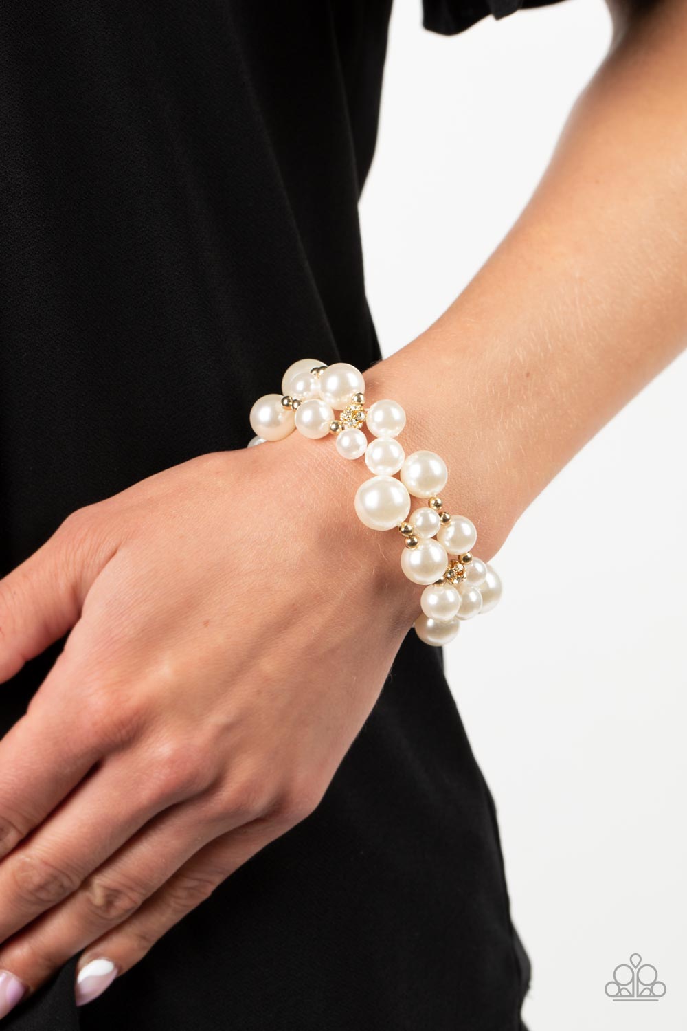 Paparazzi Accessories - Her Serene Highness - Gold Pearl Bracelets bubbly collection of white pearls, dainty gold beads, and white rhinestone encrusted accents are threaded along braided stretchy bands around the wrist, resulting in an elegant effervescence.  Sold as one individual bracelet.
