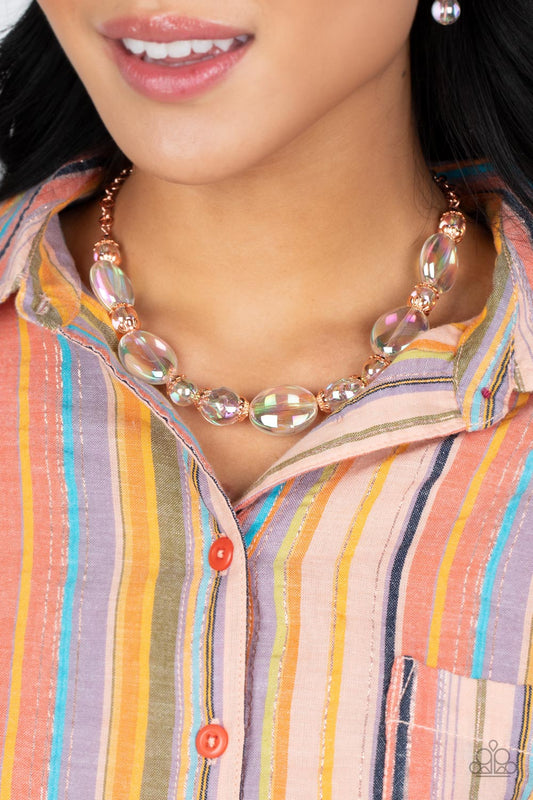 Bubbly iridescent beads in varying sizes drape along the collar, creating a glittery magical effect. Shiny copper cap fittings wrap around the smaller beads, adding vintage metallic detail to the effervescent design. Features an adjustable clasp closure. Due to its prismatic palette, color may vary.  Sold as one individual necklace. Includes one pair of matching earrings.  Get The Complete Look! Bracelet: "Iridescent Illusions - Copper" (Sold Separately)