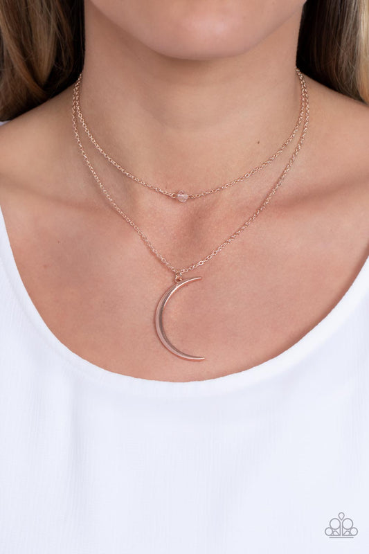 Rose Gold Necklaces two dainty rose gold chains delicately layer below the collar. A white crystal-like bead sparkles at the center of the uppermost chain while a rose gold half moon pendant swings from the bottom of the display for a mystical finish. Features an adjustable clasp closure.  Sold as one individual necklace. Includes one pair of matching earrings.