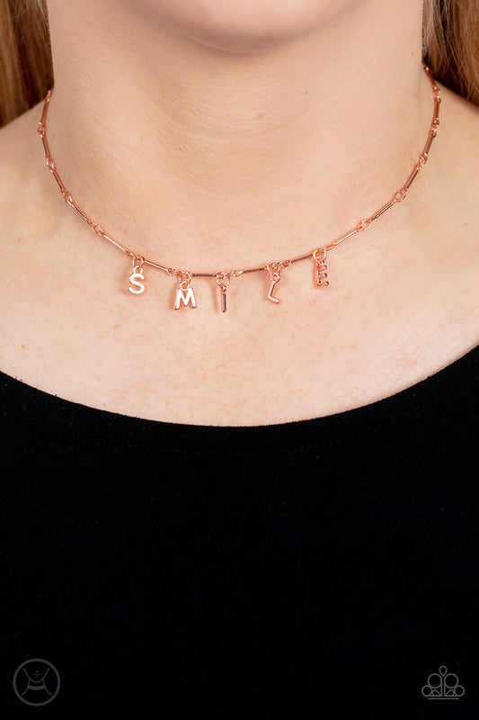 Paparazzi Accessories - Say My Name - Copper Choker Necklaces separated by dainty copper rods, copper letters spell out the word SMILE in a soft, and simple manner. Features an adjustable clasp closure.  Sold as one individual choker necklace. Includes one pair of matching earrings.