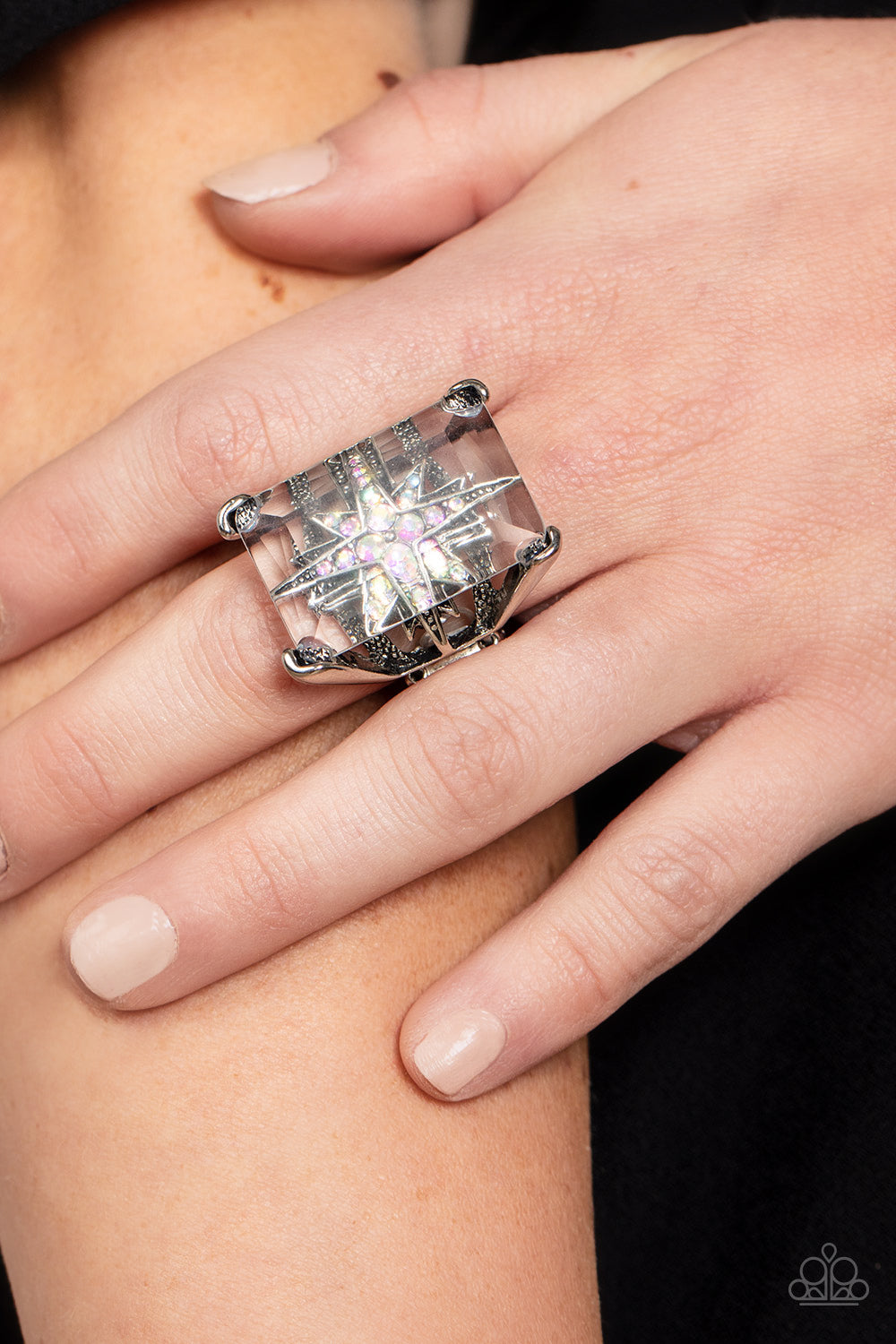Paparazzi Accessories - Starry Serenity - Multi Rings a white iridescent rhinestone-dotted star twinkles behind a glassy pane that seemingly floats atop the pronged frame, resulting in a stellar statement piece. Due to its prismatic palette, color may vary. Features a stretchy band for a flexible fit.  Sold as one individual ring.