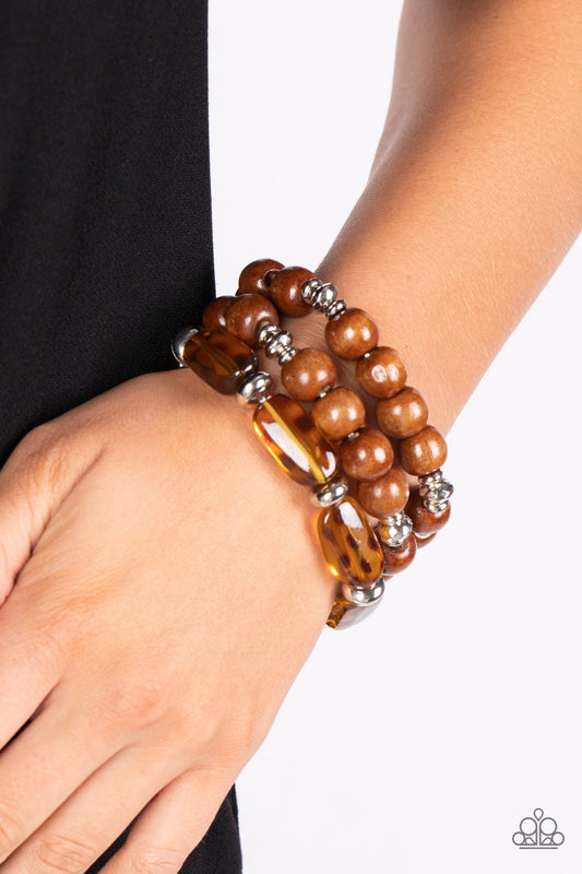 Paparazzi Accessories - WILD Mannered - Brown Cheetah- Like Bracelets featuring hints of cheetah-like patterns, glassy acrylic beads join dainty silver accents and oversized wooden beads along stretchy bands that stack across the wrist in a wildly layered finish.  Sold as one set of three bracelets.