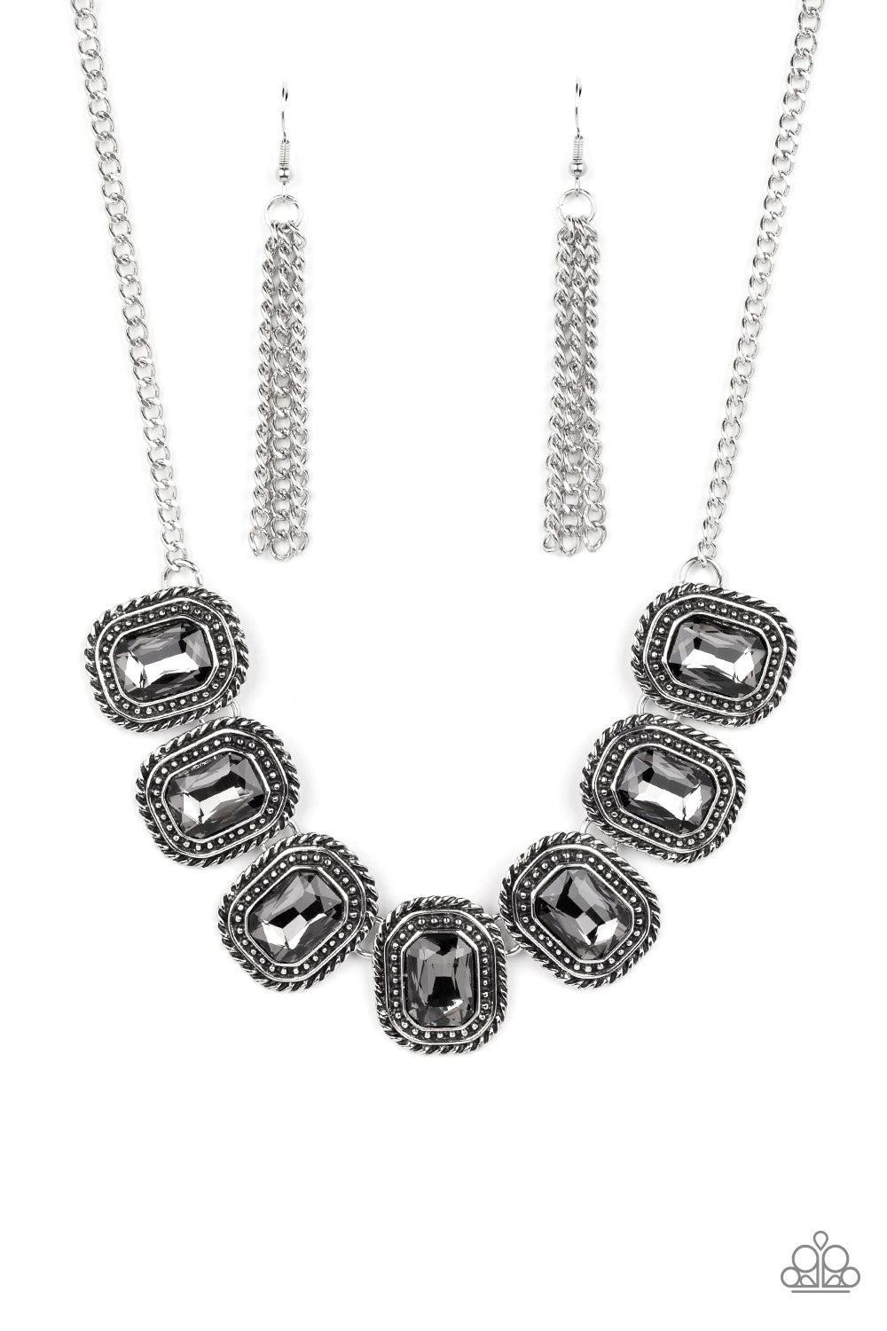 Paparazzi Accessories Iced Iron - Silver Convention Necklaces pressed into silver, chain-like frames, radiant-cut hematite rhinestones smolder below the collar in a jaw-dropping finish. Features an adjustable clasp closure.  Sold as one individual necklace. Includes one pair of matching earrings.  2022 Glow Convention 