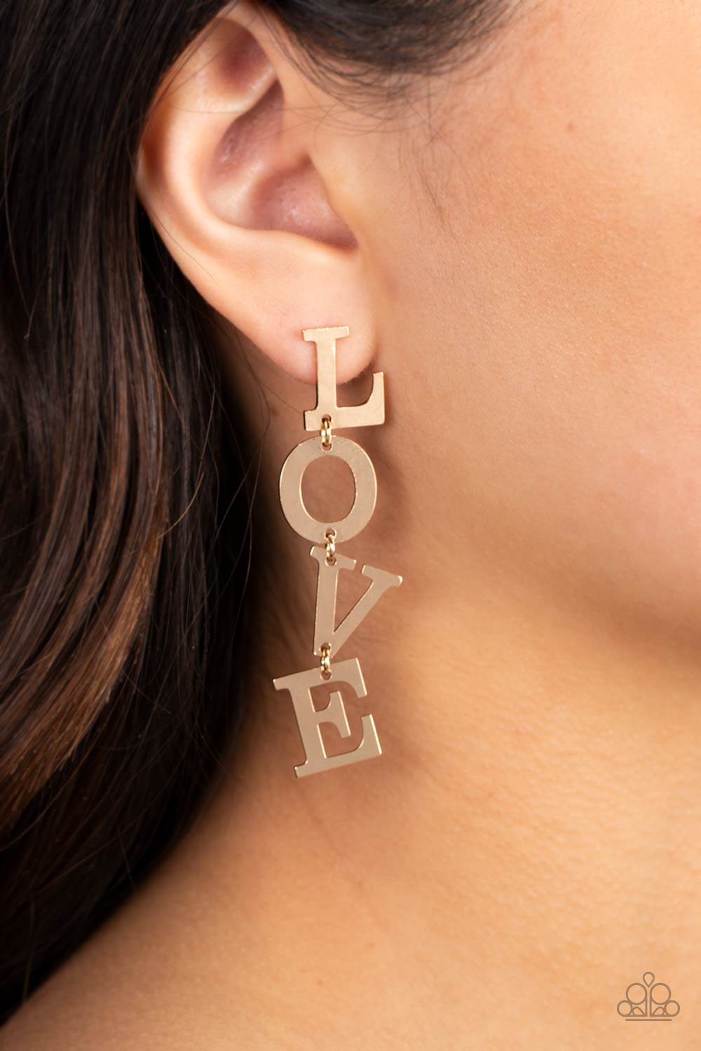 Paparazzi Accessories - L-O-V-E - Gold Earrings Gold letters with a lightly hammered sheen spell out the word "LOVE" as they vertically cascade down the ear in a flattering finish. Each of the letters are interconnected to one another giving the piece some whimsically playful movement. Earring attaches to a standard post fitting. Sold as one pair of post earrings.