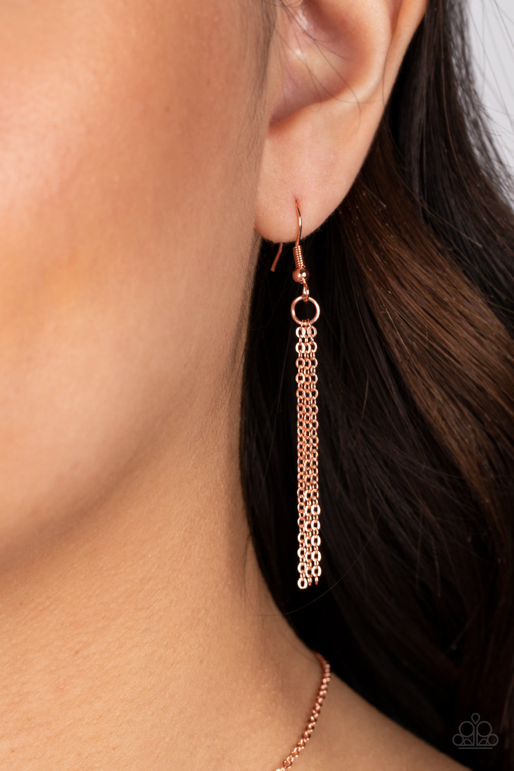 shiny copper letter "X" and a letter "O" in the same metallic sheen, slide along a classic shiny copper chain, creating a dainty, fun-loving design. Features an adjustable clasp closure.  Sold as one individual necklace. Includes one pair of matching earrings.