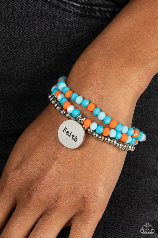 Embellished with silver and defaced beads in varying shades of blue and orange, three bracelets are threaded along elastic stretchy bands, for a fashionable stack across the wrist. Falling from one of the varying blue and orange bangles, a silver disc, with a hammered sheen, features the word "Faith," creating a simplistic collision of color and energy for a light-hearted finish.  Sold as one individual bracelet.