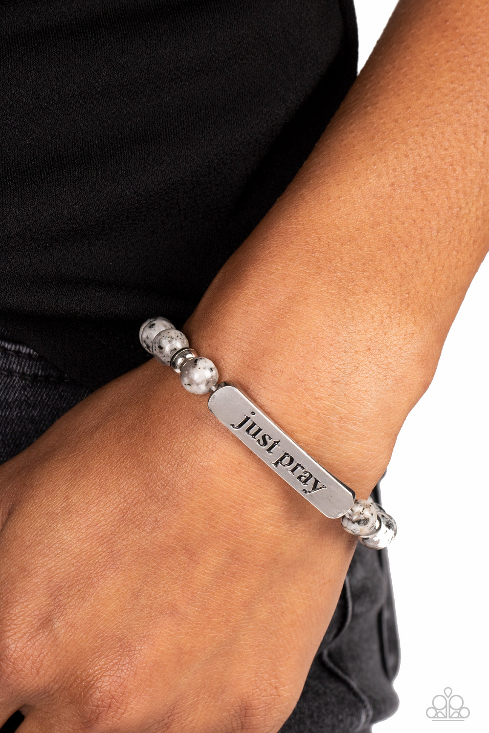 Paparazzi Accessories - Just Pray - Silver Inspirational Bracelets smooth, gray speckled stones are stretched across the wrist on an elastic stretchy band, with accents of silver beads sprinkled in. Meeting in the center of the stony display, a curved rectangular bar is stamped with the phrase "just pray" for an inspiring finish. As the stone elements in this piece are natural, some color variation is normal.  Sold as one individual bracelet.