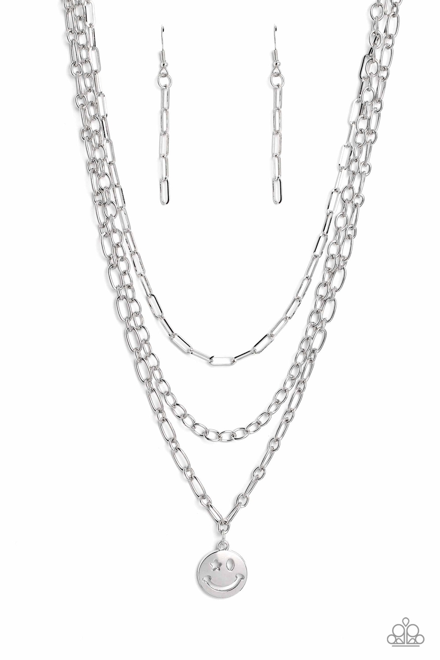 Paparazzi Accessories - Winking Wander - Silver Smiley Ncoalescetrio of silver paperclip, classic, and oval link chains coalesces down the neckline for a monochromatic masterpiece. Strung on the lowermost oval link chain, a silver smiley face pendant, with a star mimicking a wink for one of its eyes, stands out and reflects light in every direction for a statement finish. Features an adjustable clasp closure.   Sold as one individual necklace. Includes one pair of matching earrings.