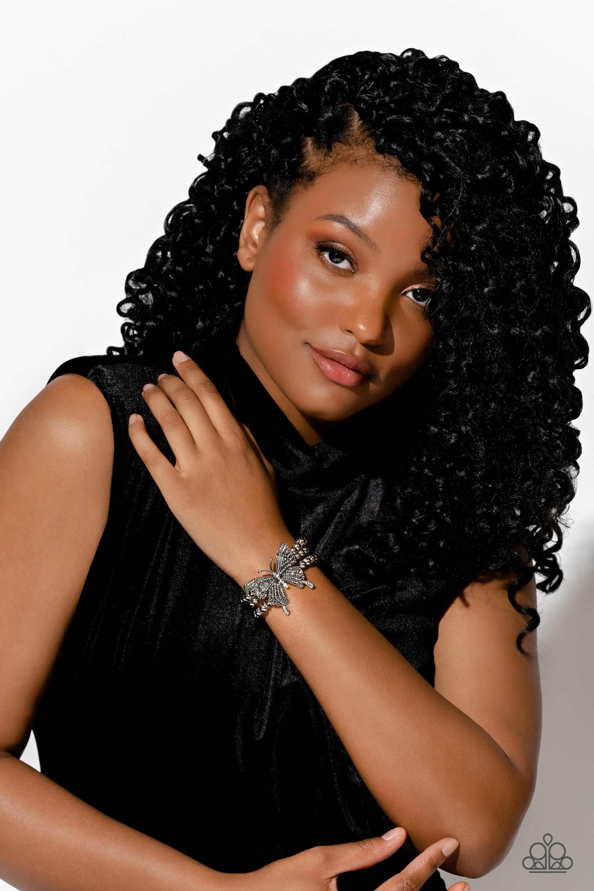 Paparazzi Accessories - First WINGS First - White 2023 EMP Butterfly Bracelets strung along elastic stretchy bands, a trio of silver and textured silver beads and accents wrap around the wrist. Featured atop the beaded collection, an oversized silver butterfly, with intricate details, is sprinkled with dainty white rhinestones across its wings and body, for a dramatically dazzling finish.  Sold as one individual bracelet.