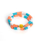 Paparazzi Accessories - In SMILE - Orange Smiley Bracelets coral, blue, and white rubber discs combine with sporadically placed silver beads to provide a vibrant pop of color along the wrist. Meeting in the center of one of the multi-shaded bracelets, a yellow bead with a smiley face, featuring stars for eyes, rests for a youthful finish.  Sold as one set of two bracelets.