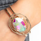 Paparazzi Accessories - Substantial Sorceress - Multi Bracelets featured in the center of airy, shiny gold bands, an oversized, faceted iridescent oval gem rests atop the wrist for a dazzling pop of color. Warped, shiny gold rings seemingly float around the sparkly gem for a whimsical finish. Features a hinged closure. Due to its prismatic palette, color may vary.