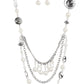 Paparazzi Accessories All the Trimmings - White Necklaces a silky ivory ribbon replaces a traditional chain to create an elegant look. Pearly ivory beads and funky silver pieces intermix with varying lengths of silver chains to give a fresh take on a Victorian-inspired piece.