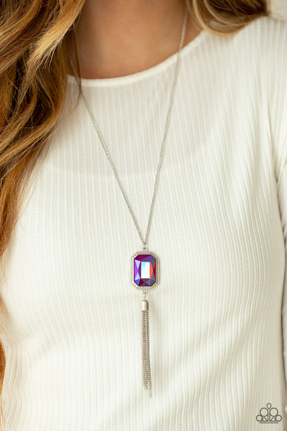 Blissed Out Opulence - Pink Iridescent Necklaces an impressive pink emerald cut gem is pressed into the center of a silver studded frame, creating an ethereal pop of color at the bottom of a lengthened silver chain. A silver chain tassel swings from the bottom of the pendant, adding flirtatious movement to the opulent display. Features an adjustable clasp closure.  Sold as one individual necklace.  Paparazzi Jewelry is lead and nickel free so it's perfect for sensitive skin too!