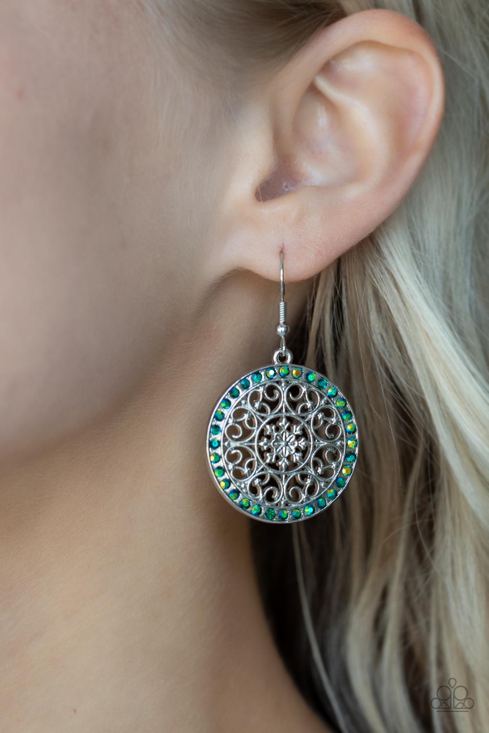 Bollywood Ballroom - Green Iridescent Earrings infused with a border of iridescent green rhinestones, studded silver heart shape filigree fans out from a decorative silver floral center for a whimsical look. Earring attaches to a standard fishhook fitting.  Sold as one pair of earrings.  Paparazzi Jewelry is lead and nickel free so it's perfect for sensitive skin too!