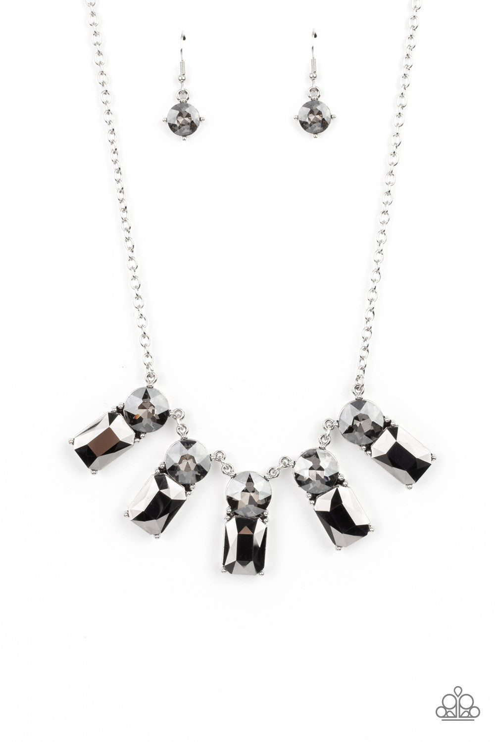 Paparazzi Accessories Celestial Royal - Silver Necklaces featuring classic pronged fittings, a dramatic collection of oversized smoky rhinestones and emerald cut hematite gems fan out below the collar for an outrageous sparkle. Features an adjustable clasp closure.