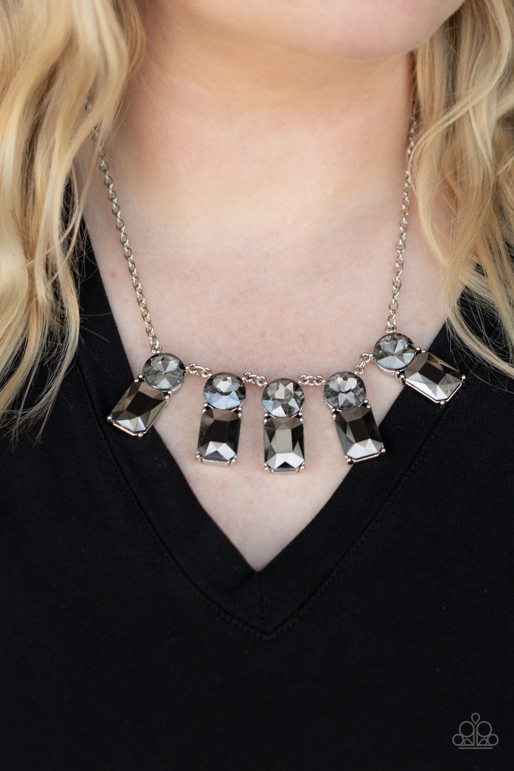 Paparazzi Accessories Celestial Royal - Silver Necklaces featuring classic pronged fittings, a dramatic collection of oversized smoky rhinestones and emerald cut hematite gems fan out below the collar for an outrageous sparkle. Features an adjustable clasp closure.