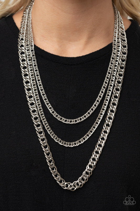 Chain of Champions - Silver Layered Necklaces bold layers of glistening silver chains of varying sizes and textures, fall like a weighty medal across the chest creating an edgy industrial effect. Features an adjustable clasp closure.  Sold as one individual necklace. Includes one pair of matching earrings.  Paparazzi Jewelry is lead and nickel free so it's perfect for sensitive skin too!