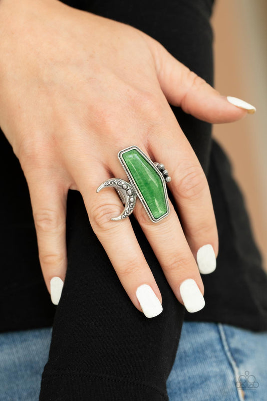 Cosmic Karma - Green Geometric Rings encased in a raised silver fitting, a geometric jade stone is flank by a decorative row of silver studs and an ornate half moon frame for a seasonal statement. The oversized frame is attentional, creating the illusion of multiple rings. Features a stretchy band for a flexible fit.
