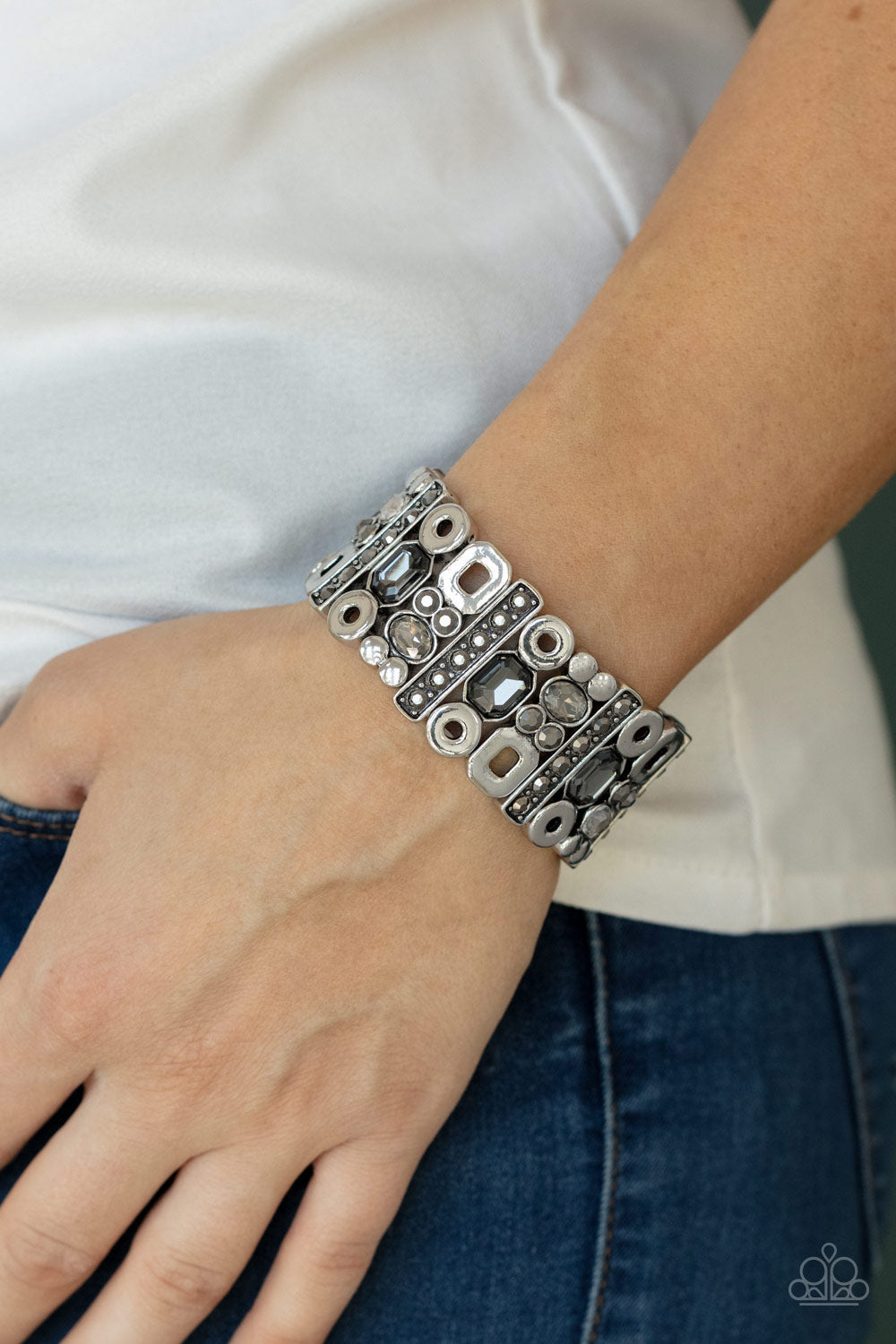 Paparazzi Accessories Dynamcally Diverse - Silver Stretch Bracelets infused with flat silver studs and geometric silver accents, a mismatched assortment of oval, round, and emerald style hematite and smoky rhinestones coalesce into edgy frames along a stretchy band for an intense sparkle around the wrist.