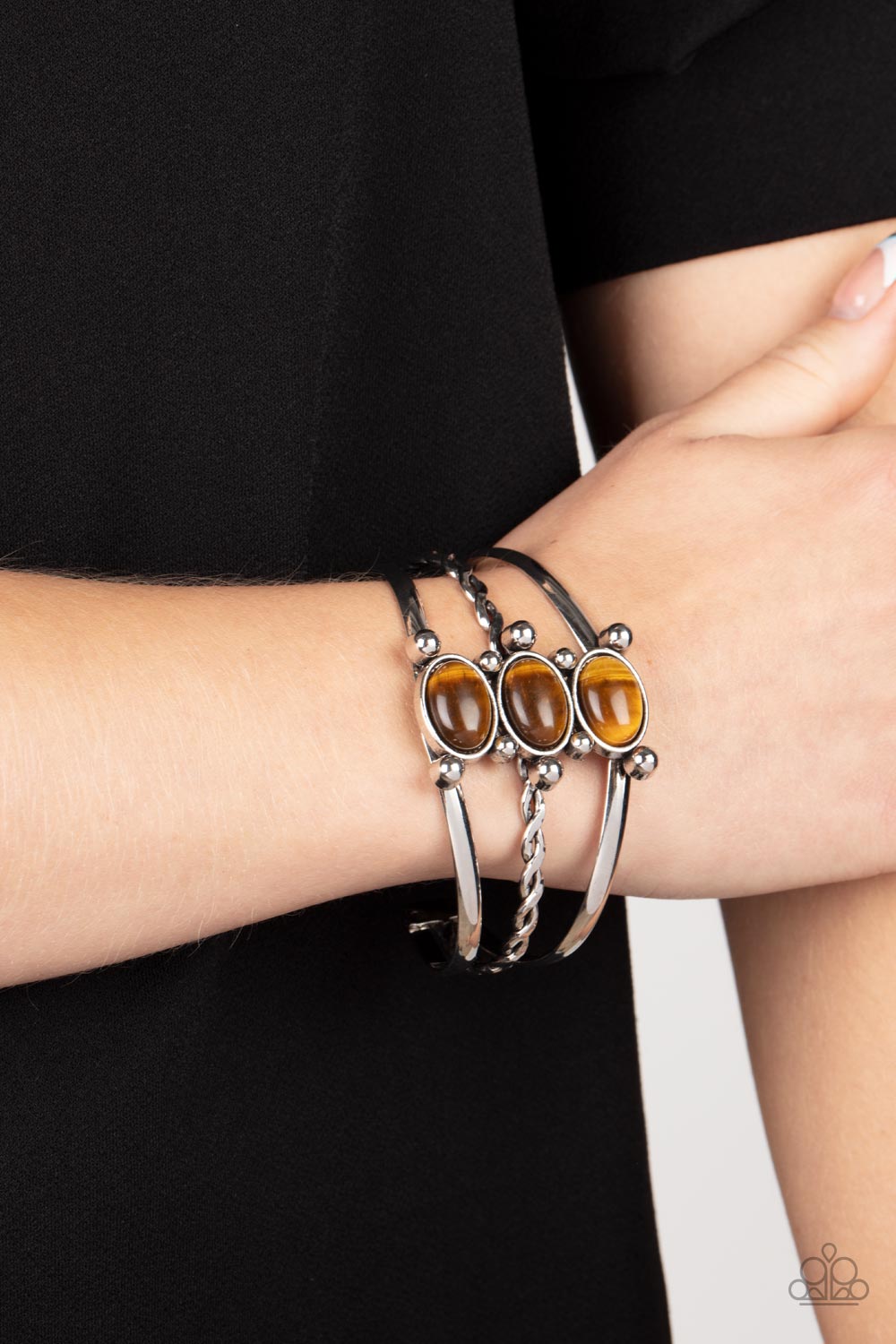 Extra Earthy - Brown Tiger's Eye Bracelets featuring silver studded fittings, an earthy trio of oval tiger's eye stones adorn the center of an ornately layered silver cuff for a seasonal finish.  Sold as one individual bracelet.