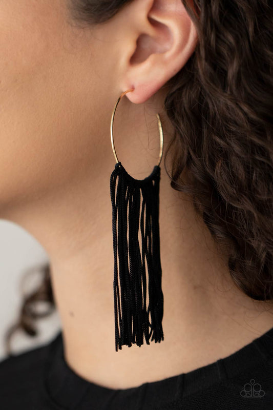 Flauntable Fringe - Gold Hoop Fringe Earrings curtain of black cords stream from the center of a dainty gold hoop, creating a glamorous fringe. Earring attaches to a standard post fitting. Hoop measures approximately 1 3/4" in diameter.  Sold as one pair of hoop earrings.