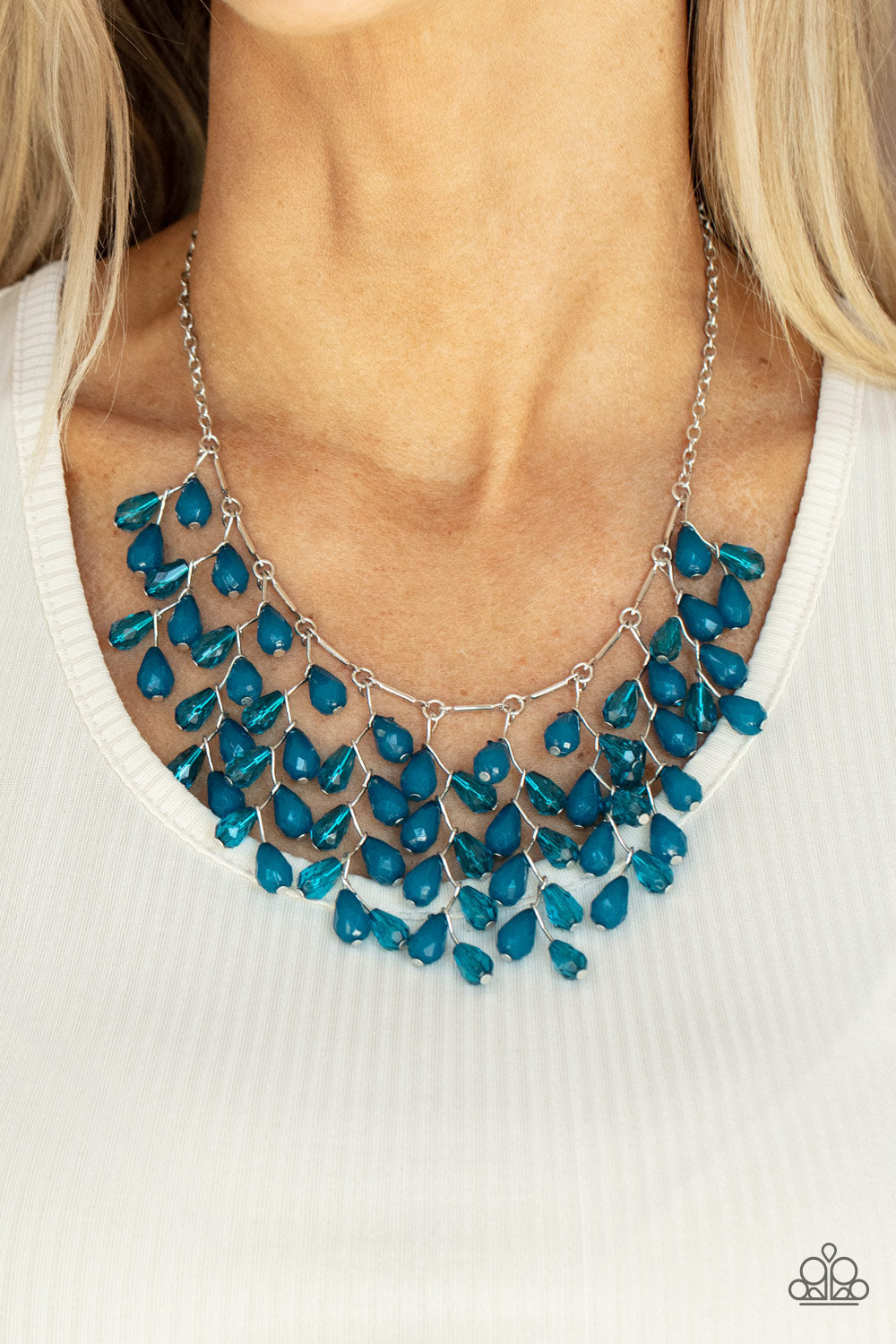 Paparazzi Accessories Garden Fairytale - Blue Necklaces a shimmery collection of opaque and clear crystal-like Mykonos Blue teardrop beads delicately cluster along a linked strand of silver bars, creating an ethereally leafy fringe below the collar. Features an adjustable clasp closure.