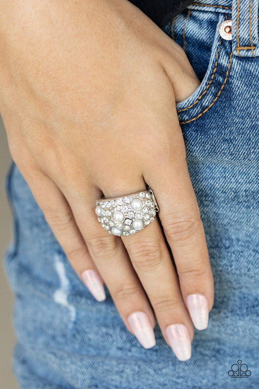 Paparazzi Accessories Gatsbys Girl - White Pearl Rings an explosion of dainty white rhinestones and bubbly white pearls are encrusted across the front of a thick silver band, creating a glamorous centerpiece atop the finger. Features a stretchy band for a flexible fit.