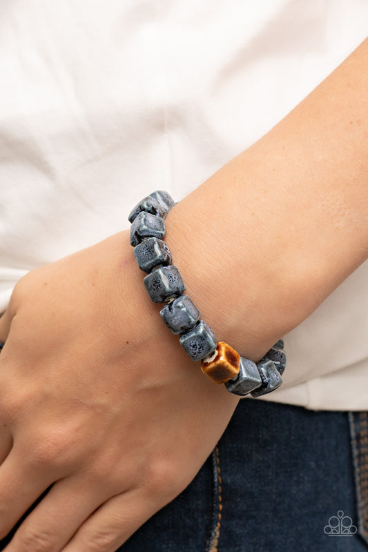 Glaze Craze - Blue Ceramic Bead Bracelets - Paparazzi Accessories featuring distressed blue and brown glazed finishes, a rustic collection of ceramic cube beads are threaded along stretchy bands around the wrist for a colorful flair.  Sold as one individual bracelet.